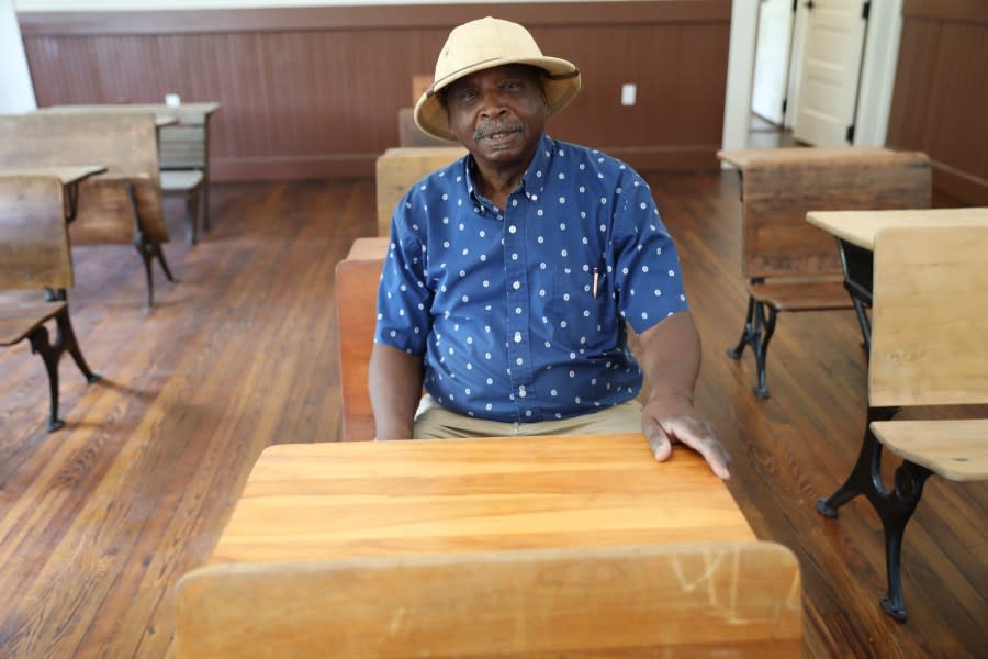 Ralph James sits in a classroom at a restored Rosenwald School made to look like it did when the school was open in St. George, S.C., on Tuesday, July 11, 2023. Jewish businessman Julius Rosenwald donated money to help build 5,000 schools for Black students across the American South a century ago. Only about 500 are standing and roughly half of them have been restored. (AP Photo/Jeffrey Collins)