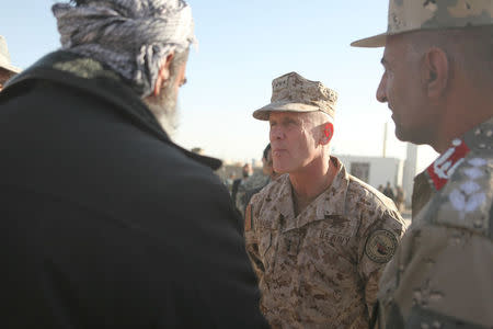 Vice Admiral Robert S. Harward, commanding officer of Combined Joint Interagency Task Force 435, greets an Afghan official during his visit to Zaranj, Afghanistan, January 6, 2011. Photo courtesy of Sgt. Shawn Coolman/Department of Defense/Handout via REUTERS