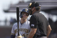 Milwaukee Brewers' Christian Yelich, left, looks to umpire Angel Hernandez after striking out against the San Francisco Giants during the ninth inning of a baseball game in San Francisco, Thursday, Sept. 2, 2021. (AP Photo/Jeff Chiu)