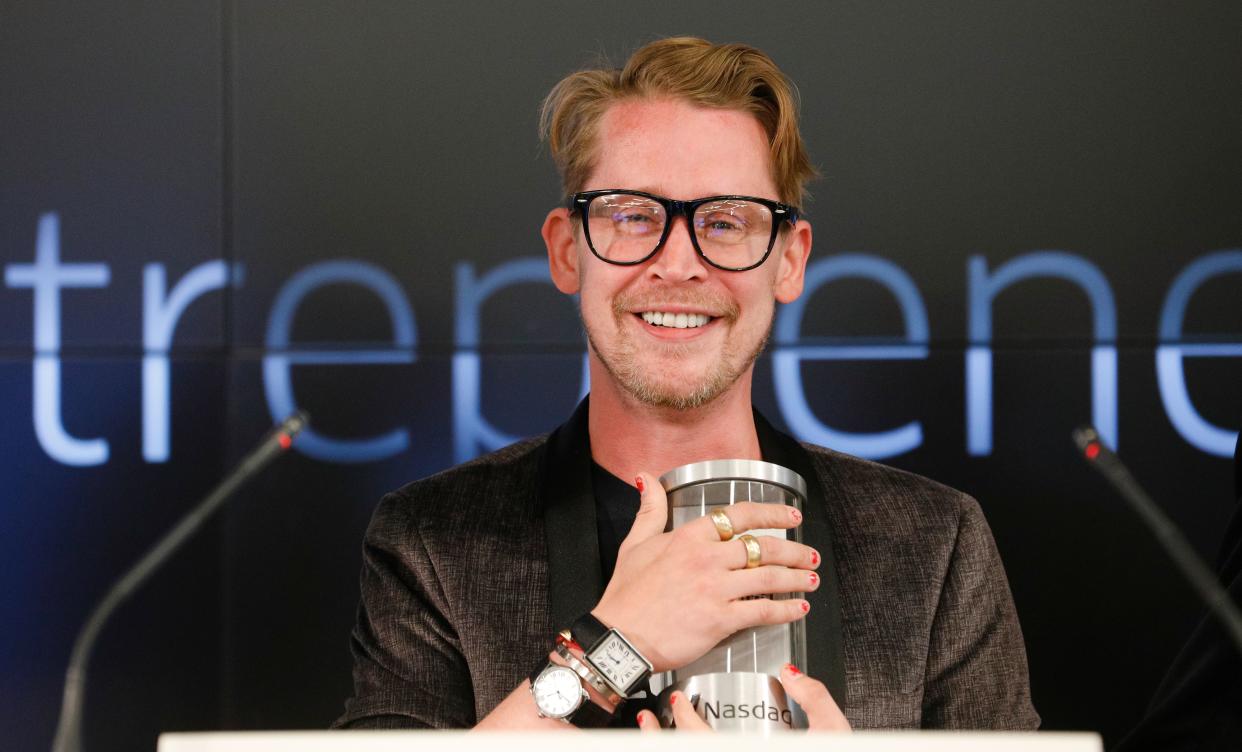 Macaulay Culkin looks dazzling in a brown suit and pant to match, with a cute smile on his face.