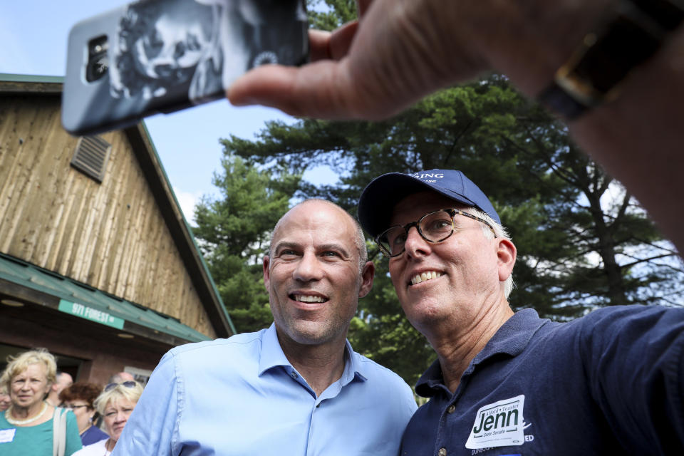 Michael Avenatti, left, an attorney and entrepreneur, has a selfie taken with Mike Munhall of Bennington after speaking at the Hillsborough County Democrats' Summer Picnic fundraiser in Greenfield, N.H., Sunday, Aug. 19, 2018. Avenatti, the attorney taking on President Donald Trump over his alleged affair with an adult film actress, is exploring a possible 2020 run for president. (AP Photo/ Cheryl Senter)