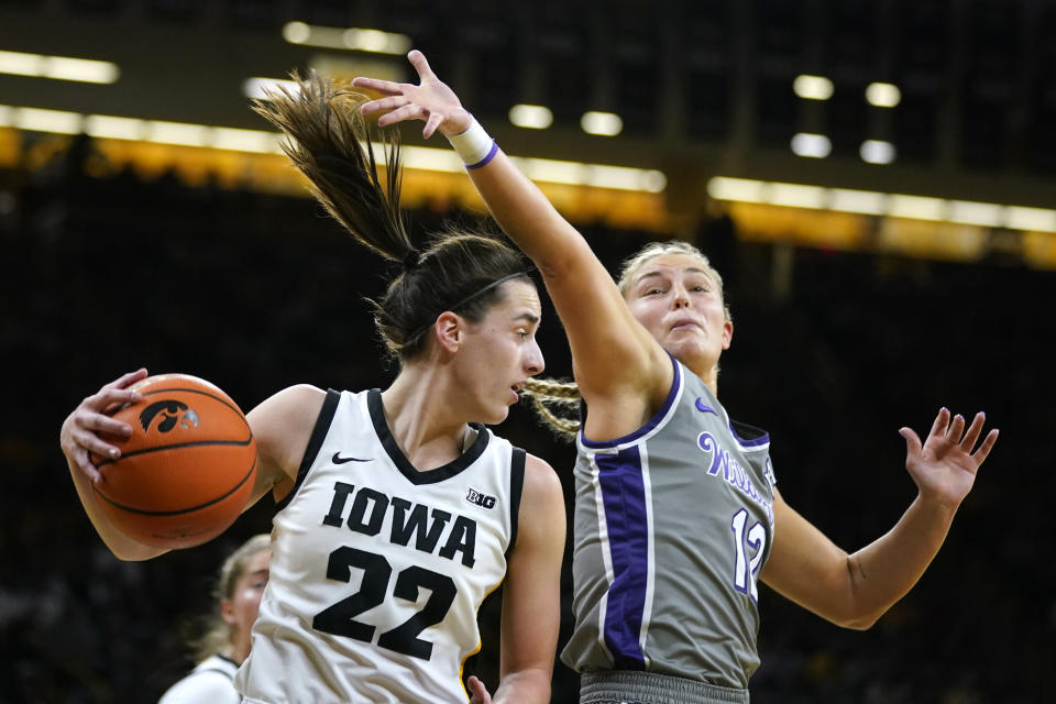 Iowa guard Caitlin Clark (22) gets a rebound next to Kansas State guard Gabby Gregory (12) during the first half of an NCAA college basketball game Thursday, Nov. 16, 2023, in Iowa City, Iowa. (AP Photo/Charlie Neibergall)