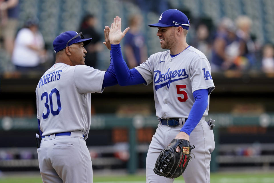 Los Angeles Dodgers manager Dave Roberts (30) and first baseman Freddie Freeman celebrate the team's 11-9 win over the Chicago White Sox in a baseball game Thursday, June 9, 2022, in Chicago. (AP Photo/Charles Rex Arbogast)