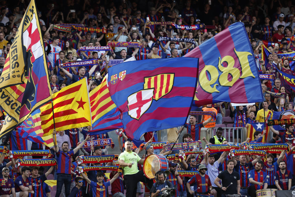 Barcelona fans bang drums, wave flags and chant before a Spanish La Liga soccer match between Barcelona and Mallorca at the Camp Nou stadium in Barcelona, Spain, Sunday, May 28, 2023. (AP Photo/Joan Monfort)