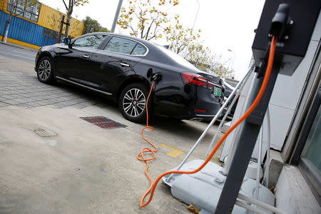 A Roewe 950 hybrid electric car is displayed with its plug-in charger at an electric car dealership in Shanghai, China, January 11, 2017. REUTERS/Aly Song