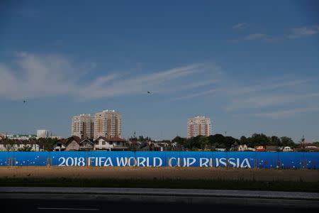 Birds fly over a "2018 FIFA World Cup Russia" banner outside the stadium in Kaliningrad, Russia, June 28, 2018. REUTERS/Kacper Pempel