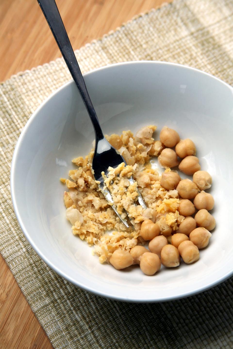 <p>Just <a href="https://www.popsugar.com/fitness/How-Add-More-Protein-Your-Oatmeal-40553263" class="link rapid-noclick-resp" rel="nofollow noopener" target="_blank" data-ylk="slk:mash one-quarter cup of garbanzo beans into your bowl">mash one-quarter cup of garbanzo beans into your bowl</a>. Then add the rolled oats, liquid, sweetener, and toppings of your choice, heat it up, and boom - for 65 extra calories, you get <a href="http://www.edenfoods.com/store/images/products/nlea/102960.gif" class="link rapid-noclick-resp" rel="nofollow noopener" target="_blank" data-ylk="slk:3.5 grams of protein">3.5 grams of protein</a> and 2.5 grams of fiber. </p> <p>The smashed chickpeas add a creaminess that blends right into the oatmeal, so you won't notice them one bit. This hack works with white beans, too, and if your oatmeal is chocolate flavored, you can use black beans.</p> <p><strong>Try this recipe:</strong> <a href="https://www.popsugar.com/fitness/Banana-Cashew-Overnight-Oats-40463726" class="link rapid-noclick-resp" rel="nofollow noopener" target="_blank" data-ylk="slk:banana cashew overnight oats">banana cashew overnight oats</a></p>