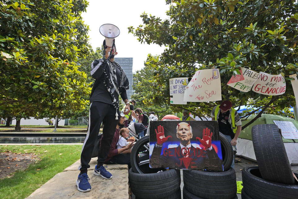 FILE - A man uses a megaphone to chant against the Israel-Hamas war at a protest site set up at the University of Texas at Dallas, Wednesday, May 1, 2024, in Richardson, Texas. (AP Photo/LM Otero, File)