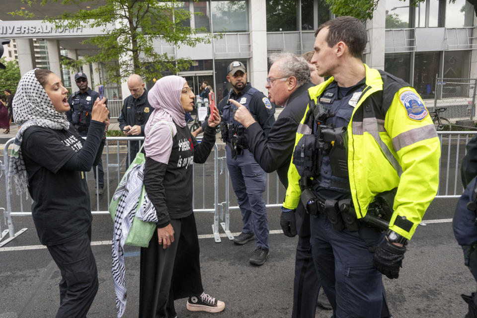 White House Correspondents' Association Dinner attendee, second right, confronts a protester before the start of the event outside the Washington Hilton on Saturday, April 27, 2024, in Washington. (AP Photo/Kevin Wolf)