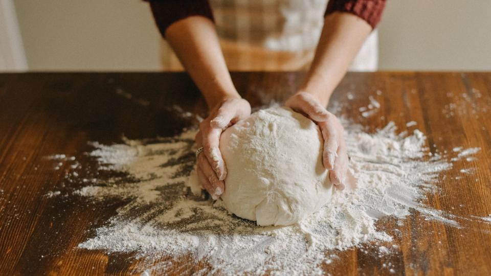 woman kneading bread dough