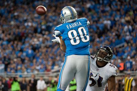 Dec 16, 2013; Detroit, MI, USA; Detroit Lions tight end Joseph Fauria (80) makes a touchdown catch will being pressured by Baltimore Ravens inside linebacker Daryl Smith (51) during the fourth quarter at Ford Field. Mandatory Credit: Tim Fuller-USA TODAY Sports