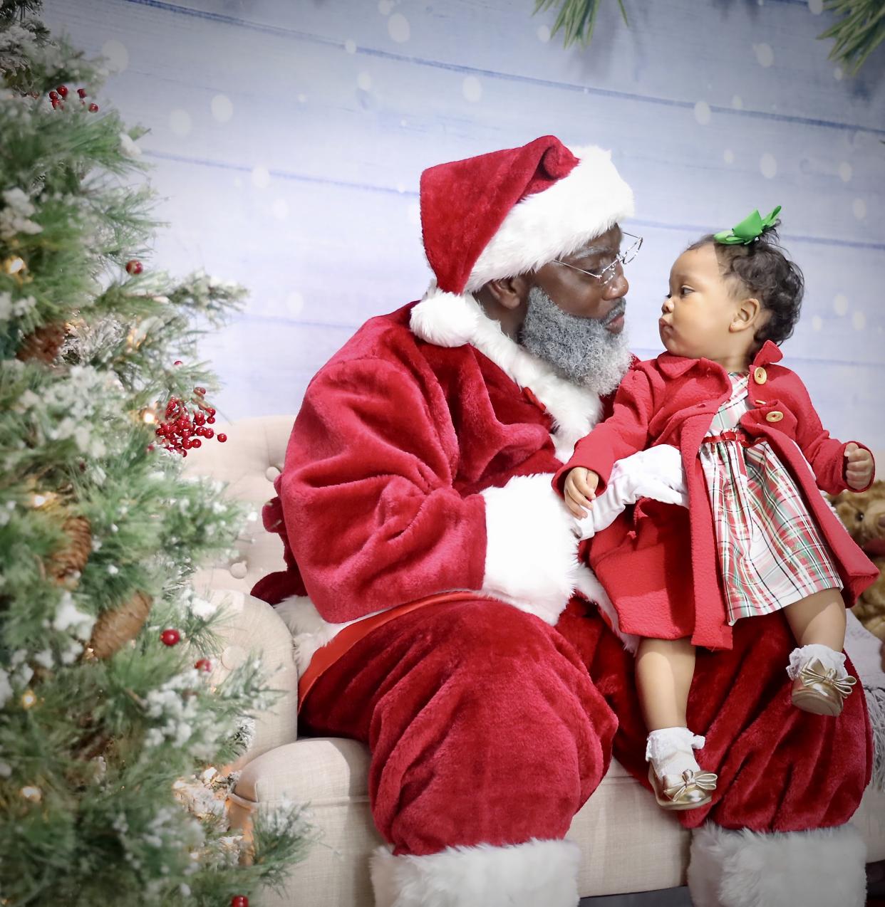 Kelvin Douglas greets a young fan as Black Santa Houston. (Photo: Black Santa Houston)