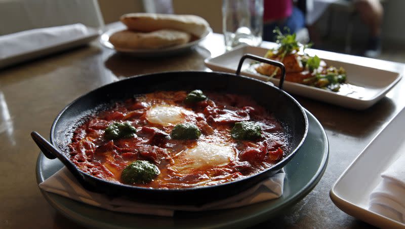 In this May 31, 2016 photo, shakshuka, which is chermoula, Jerusalem artichokes, spicy chilies, tomato and egg, sits on a table at Shaya Restaurant, in New Orleans.