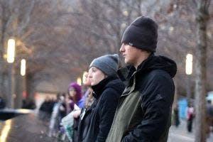 Madison Haugen, a junior clarinet player, and Zander Delperdang, a freshman trumpet player, look at the 9/11 Memorial Pool for the south tower.