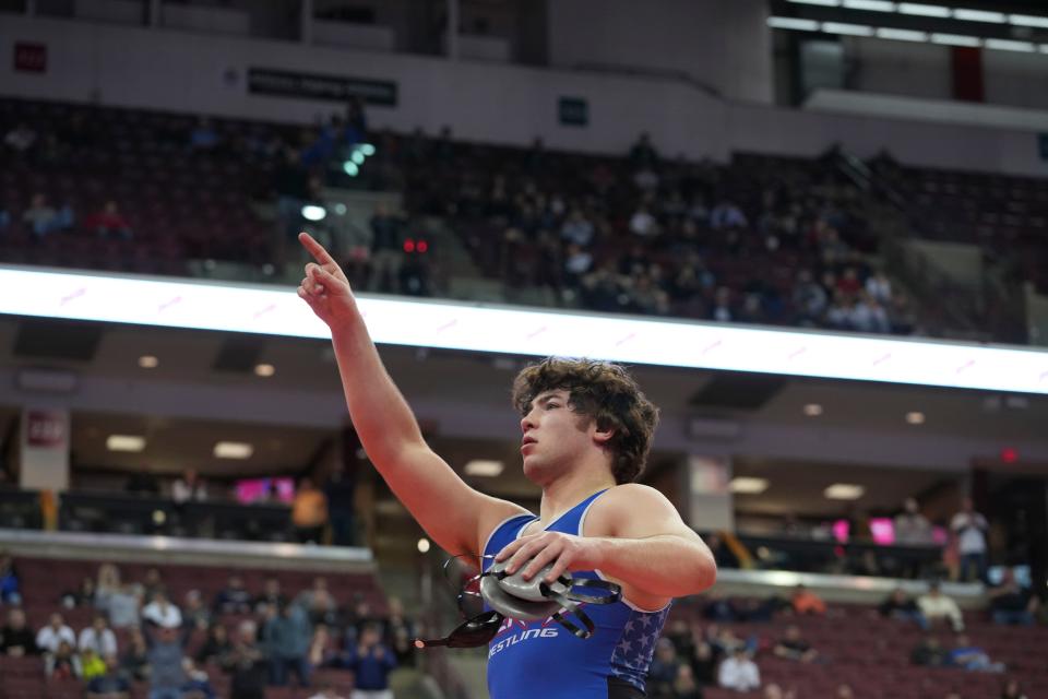 Liberty’s Dylan Russo celebrates a win during the Division I state wrestling tournament. Russo captured the championship at 215 pounds.