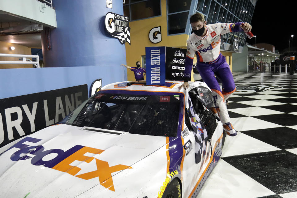 Denny Hamlin jumps from his car after winning a NASCAR Cup Series auto race Sunday, June 14, 2020, in Homestead, Fla. (AP Photo/Wilfredo Lee)