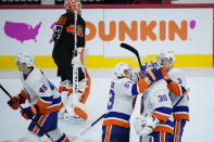 New York Islanders' Braydon Coburn (45), Casey Cizikas (53), Ilya Sorokin (30) and Adam Pelech (3) celebrate past Philadelphia Flyers' Brian Elliott (37) after the Islanders won an NHL hockey game in overtime, Sunday, April 18, 2021, in Philadelphia. (AP Photo/Matt Slocum)