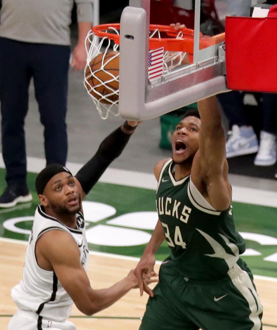 Giannis Antetokounmpo dunks over the Brooklyn Nets' Bruce Brown.