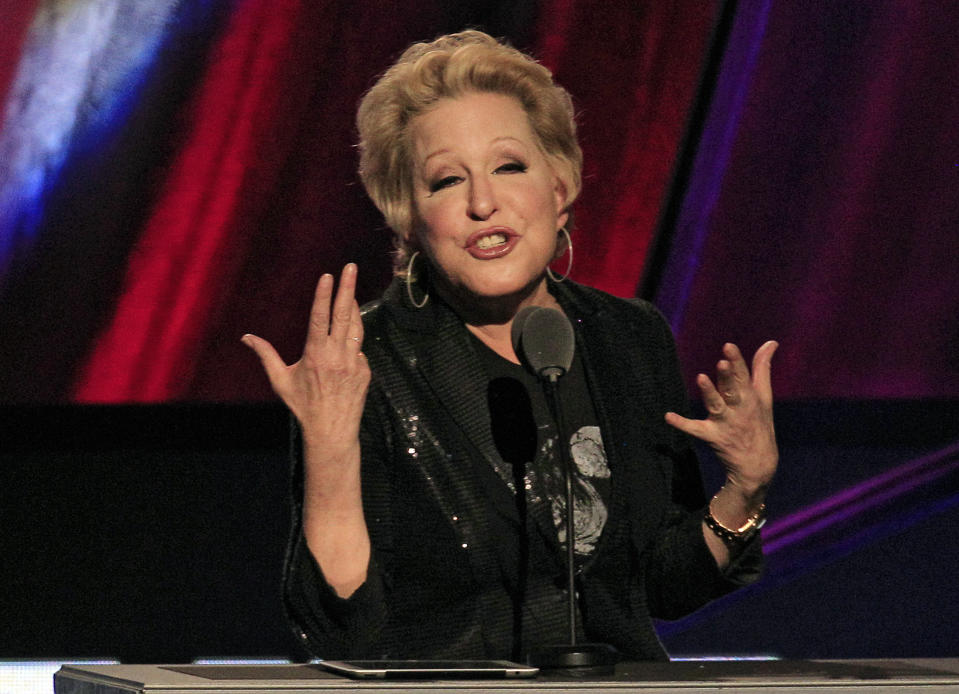 FILE - In this April 14, 2012 file photo, Bette Midler introduces the late Laura Nyro for induction into the Rock and Roll Hall of Fame in Cleveland. An online campaign to raise money so Native American tribes in South Dakota can purchase land they consider sacred has gained steam with a growing list of celebrities backing the effort. P Diddy and Midler have tweeted their support for the effort to purchase nearly 2,000 acres in the Black Hills of South Dakota. They join actor Ezra Miller and hip-hop producer Sol Guy, who appeared in a recent video online with drawing attention to the effort. (AP Photo/Tony Dejak, File)