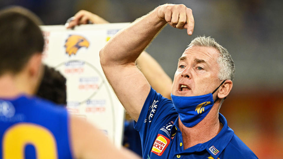 Pictured here, West Coast Eagles coach Adam Simpson speaks to his players during a break in their AFL game.