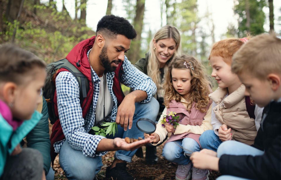 a male teacher interacting with kids