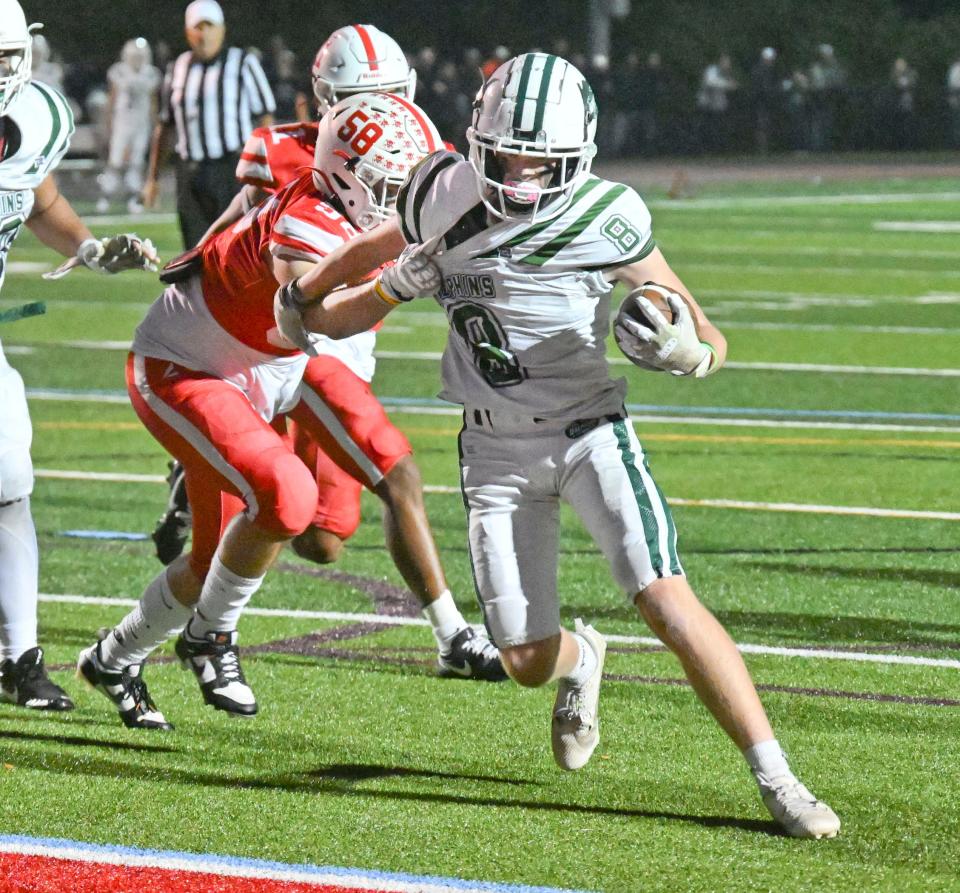 Oliver Doto of Dennis-Yarmouth breaks the tackle by Spencer Lavalley of Barnstable for a first half two point conversion.