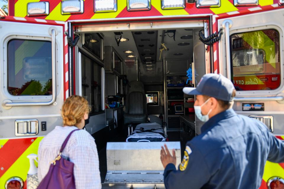 A person receives a tour of the station's rescue ambulance from a paramedic after they received a dose of the Johnson and Johnson Janssen Covid-19 vaccine at a Culver City Fire Department vaccination clinic on August 5, 2021, in California. (Photo by Patrick T. FALLON / AFP) (Photo by PATRICK T. FALLON/AFP via Getty Images)