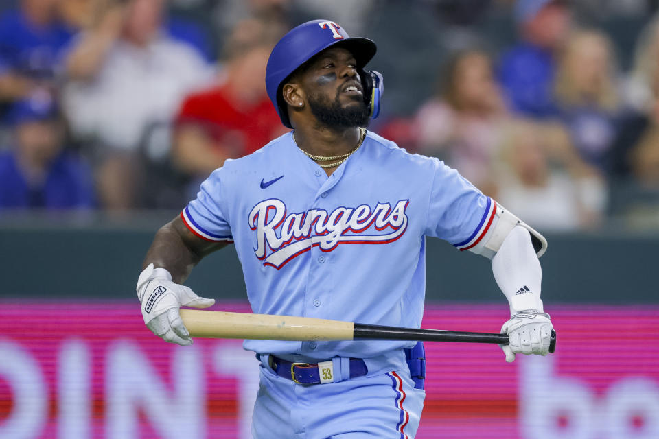 Texas Rangers' Adolis Garcia reacts after striking out in the third inning of a baseball game against the Cleveland Guardians, Sunday, July 16, 2023, in Arlington, Texas. (AP Photo/Gareth Patterson)