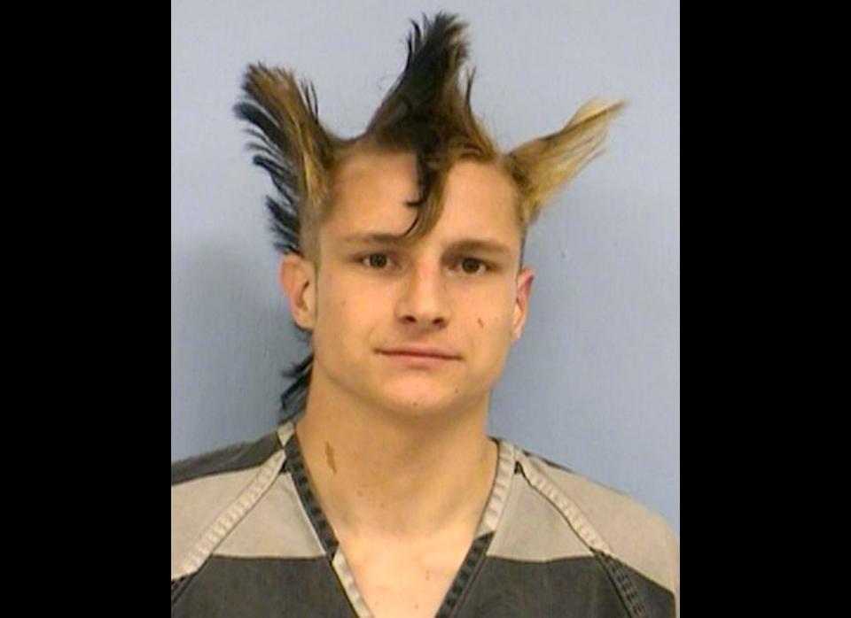 Johnathan Washburn, 23, allegedly hit a man on the head with a skateboard after he took a picture of his bizarre triple-mohawk hairstyle - landing him in police custody. 