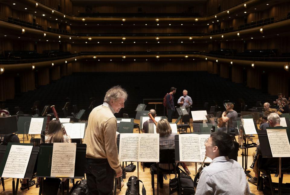 Thierry Fischer, music director of the Utah Symphony, left, speaks with French horn player Jonathan Chiou before rehearsal at Abravanel Hall in Salt Lake City on Thursday, May 25, 2023. Fischer concludes his 14 years with the symphony this weekend. | Laura Seitz, Deseret News