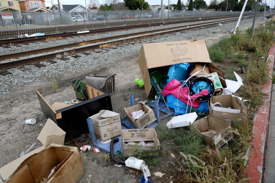 Discarded items and trash alongside train tracks in Watts.