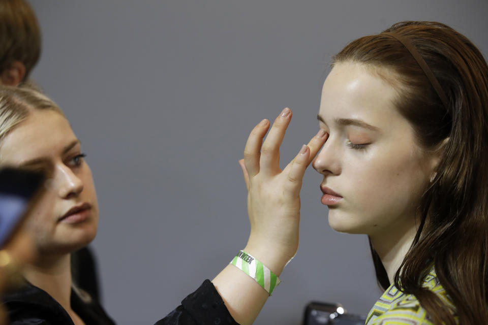 A model has make up applied backstage prior to the N. 21 Spring-Summer 2020 collection, unveiled during the fashion week, in Milan, Italy, Wednesday, Sept. 18, 2019. (AP Photo/Luca Bruno)