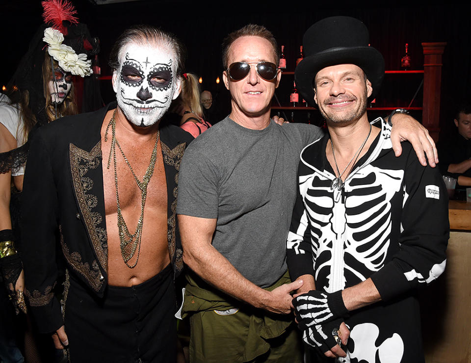 <p>Seacrest (right) threw on a skeleton onesie and a top hat for the Casamigos Tequila fiesta, where he partied with peeps including talent manager Geyer Kozinsky (center). (Photo: Michael Kovac/Getty Images) </p>