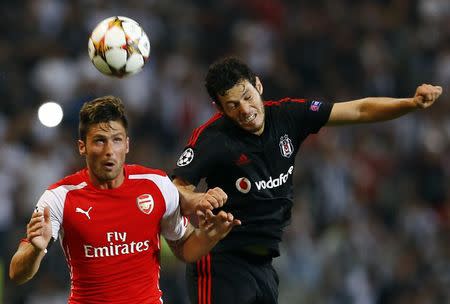 Arsenal's Olivier Giroud (L) fights for the ball with of Besiktas' Pedro Franco during the first leg of their Champions League qualifying soccer match at Ataturk Olympic stadium in Istanbul August 19, 2014. REUTERS/Murad Sezer