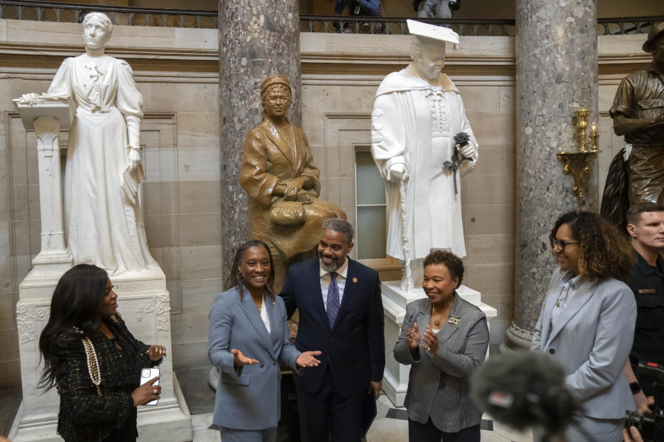 Sen. Laphonza Butler, D-Calif., second from left, reacts after being sworn into the Congressional Black Caucus by Rep. Steven Horsford, D-Nev., third from left, in front of a statue of Rosa Parks in the Hall of Statuary on Capitol Hill, Tuesday, Oct. 3, 2023 in Washington. (AP Photo/Mark Schiefelbein)