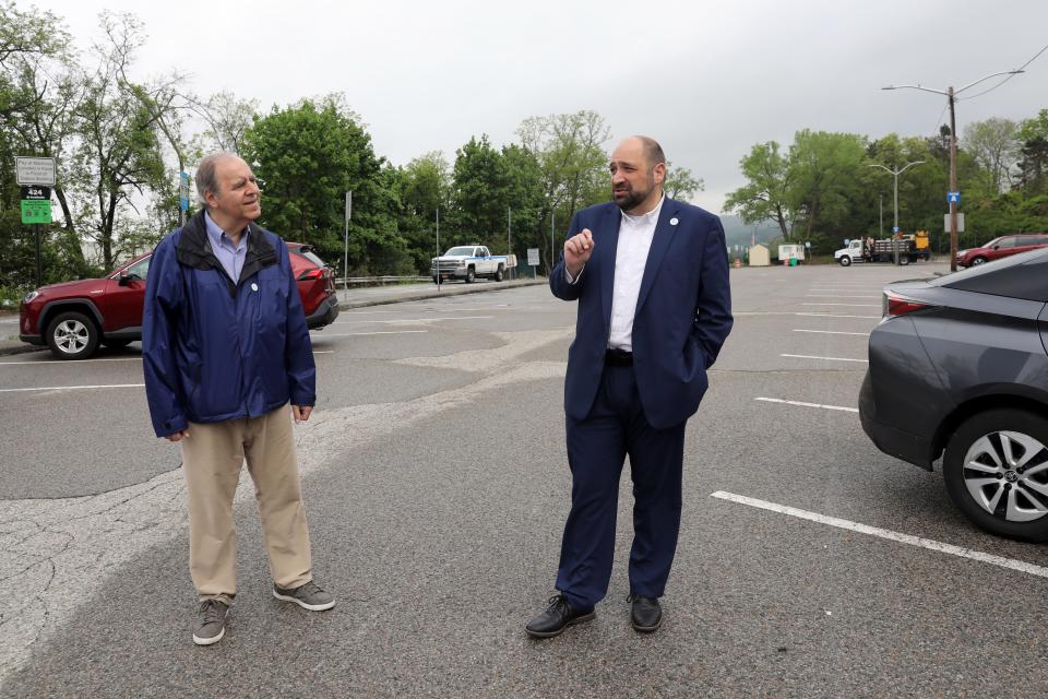 Deputy Mayor/Trustee Len Simon, left, and Mayor Brian Pugh talk about the proposed housing redevelopment project at the site, which is a parking lot across the street from the train station in Croton-on-Hudson, May 8, 2024.