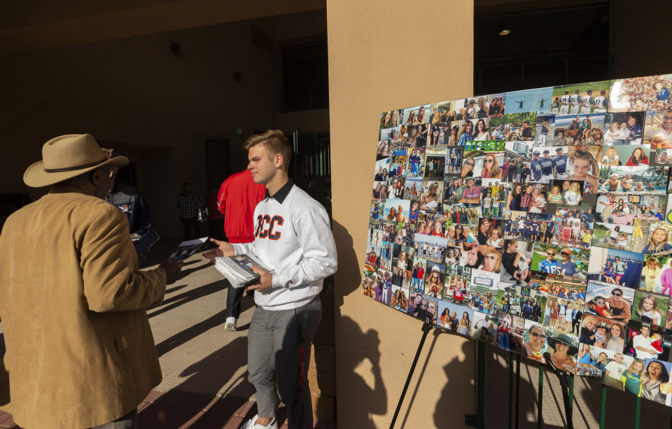 Orange Coast College students welcome those attending a memorial service Monday, Feb. 10, 2020, at Angel Stadium of Anaheim in Anaheim, Calif., honoring baseball coach John Altobelli, his wife, Keri, and their daughter Alyssa, who all died in a helicopter crash Jan. 26 in Calabasas, Calif. (AP Photo/Damian Dovarganes)