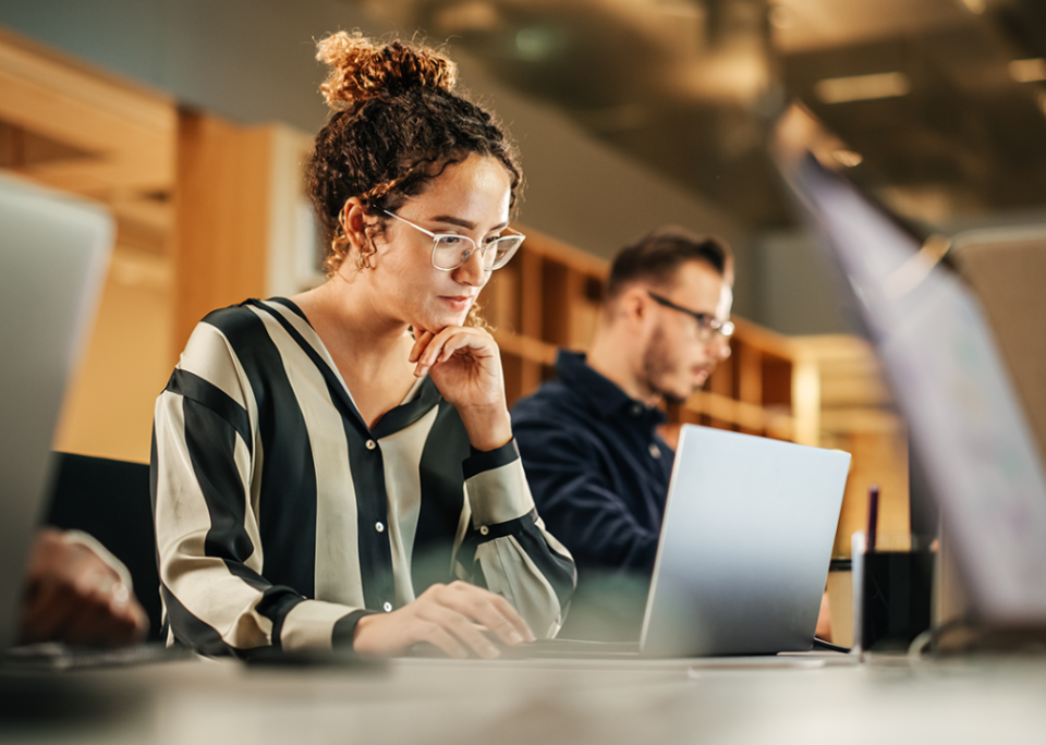 Professional woman at desk in modern office.