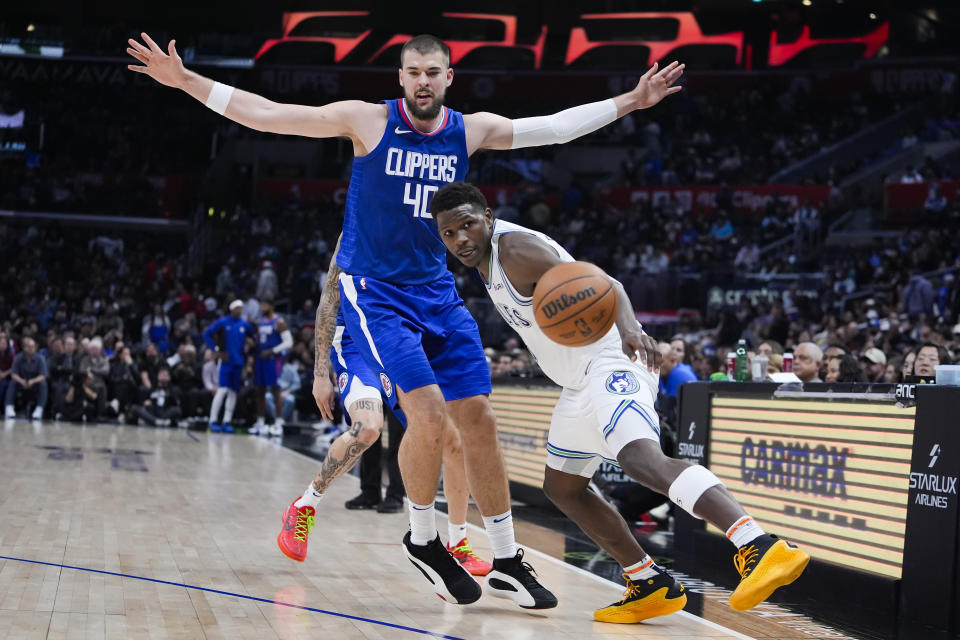 Minnesota Timberwolves guard Anthony Edwards, right, drives against Los Angeles Clippers center Ivica Zubac during the second half of an NBA basketball game, Monday, Feb. 12, 2024, in Los Angeles. (AP Photo/Ryan Sun)