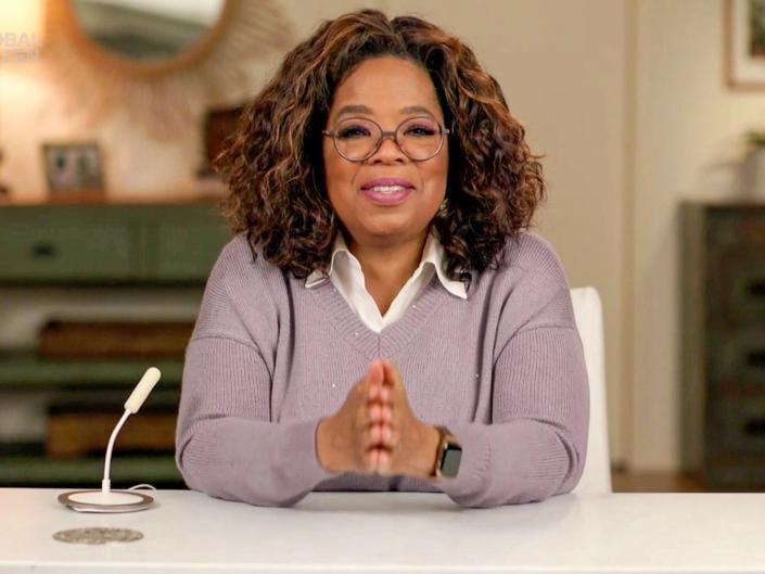 Oprah Winfrey sitting at desk