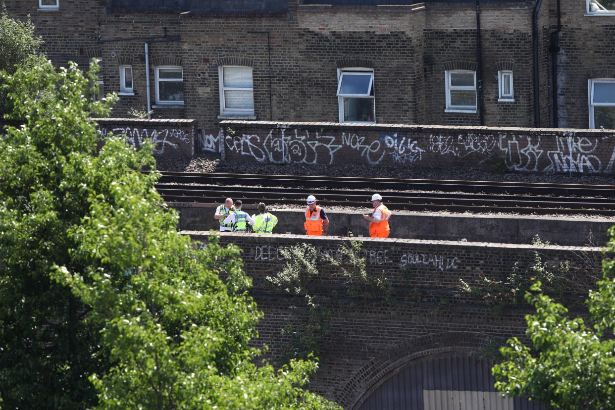 Police and Network Rail engineers at the scene in Loughborough Junction: PA