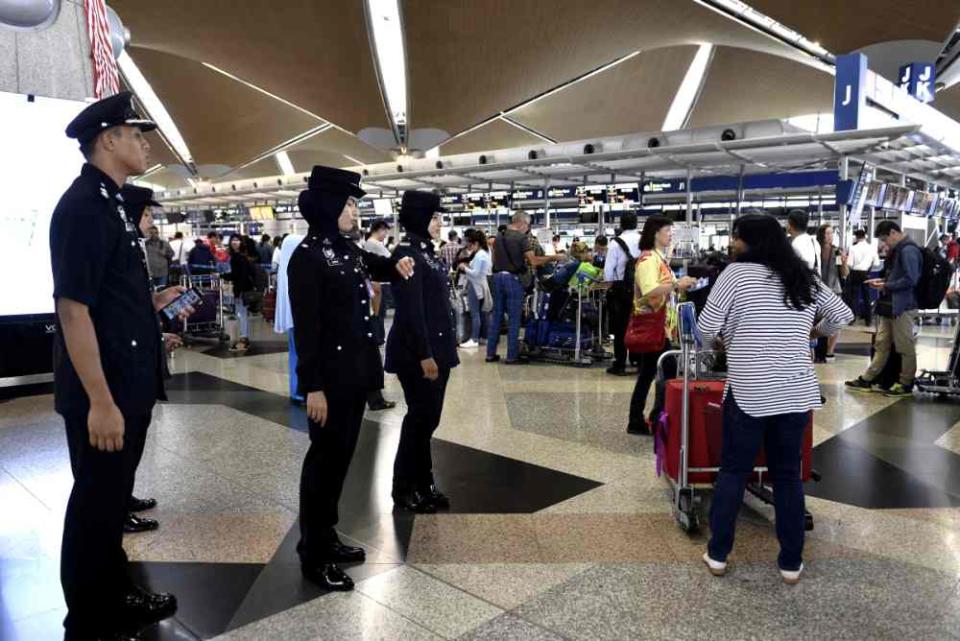 Passengers queue up to check-in for their flights at the Kuala Lumpur International Airport in Sepang August 24, 2019.