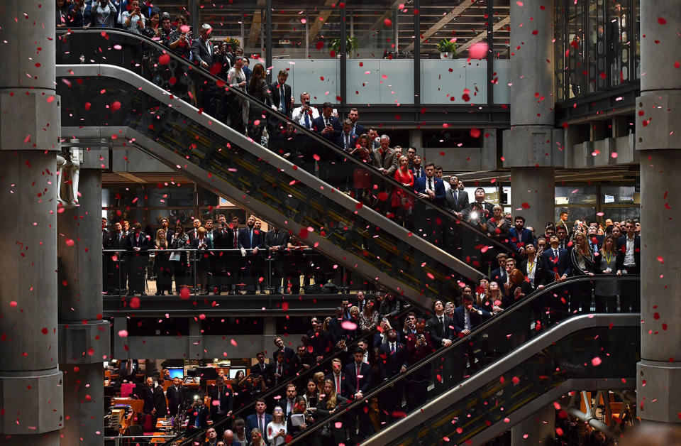 <p>Red poppies fall from above as employees observe a minute’s silence in commemoration of Remembrance Day, inside Lloyd’s of London in the city of London on Nov. 9, 2018. – Nov. 11, 2018 is the 100th anniversary of the end of WWI. In the run-up to Armistice Day, many Britons wear a paper red poppy — symbolising the poppies which grew on French and Belgian battlefields during World War I. (Photo from Ben Stansall/AFP/Getty Images) </p>
