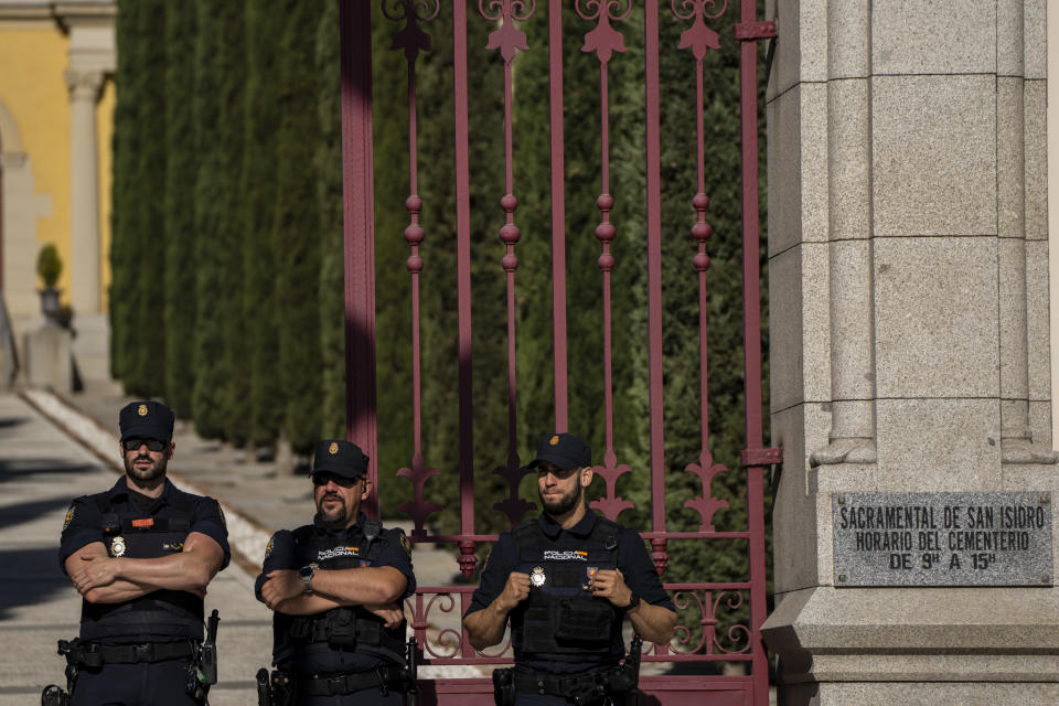 Police officers stand outside the San Isidro Cemetery in Madrid, Spain, Monday, April 24, 2023. The body of Jose Antonio Primo de Rivera, the founder of Spain’s fascist Falange movement, is exhumed from a Madrid mausoleum and transferred to a city cemetery. (AP Photo/Manu Fernandez)