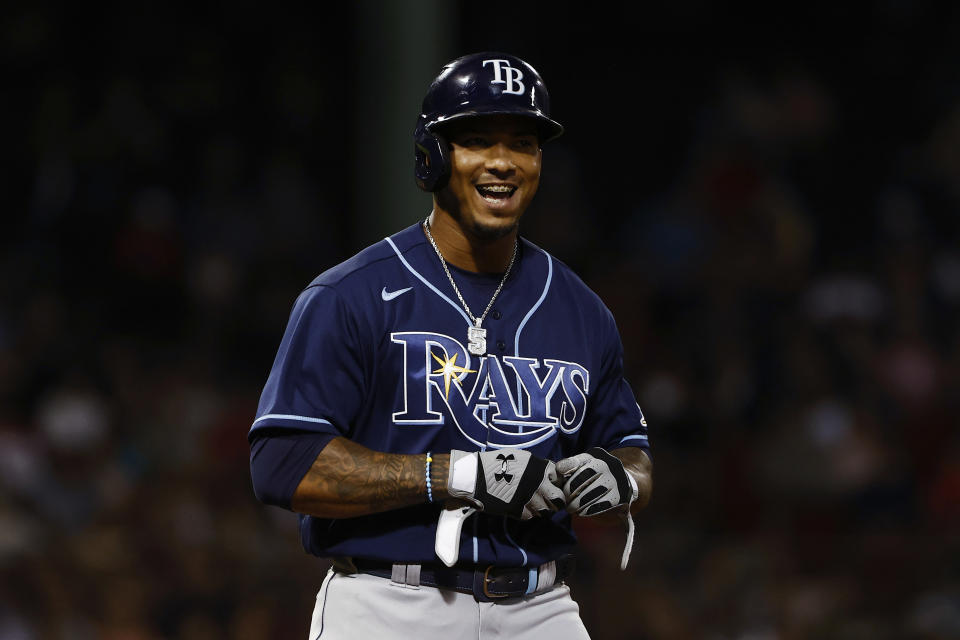 Tampa Bay Rays' Wander Franco smiles while talking to Boston Red Sox players in the dugout after he reached base on a walk during the eighth inning of a baseball game Wednesday, Sept. 8, 2021, at Fenway Park in Boston. (AP Photo/Winslow Townson)