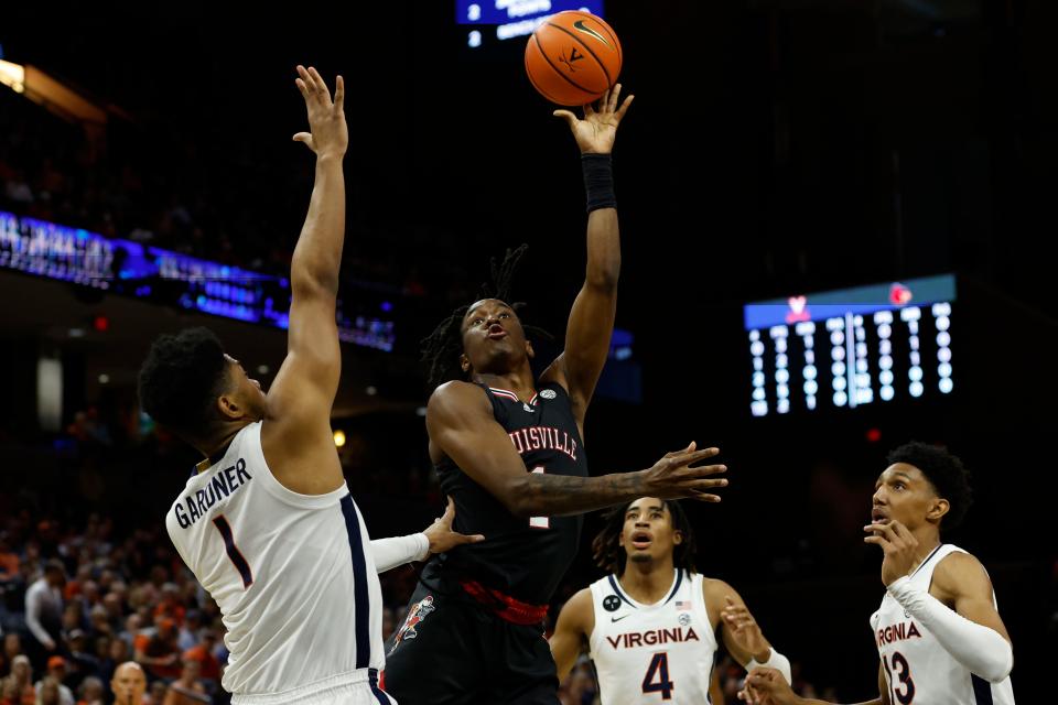 Mar 4, 2023; Charlottesville, Virginia, USA; Louisville Cardinals guard Mike James (1) shoots the ball as Virginia Cavaliers forward Jayden Gardner (1) defends in the first half at John Paul Jones Arena. Mandatory Credit: Geoff Burke-USA TODAY Sports