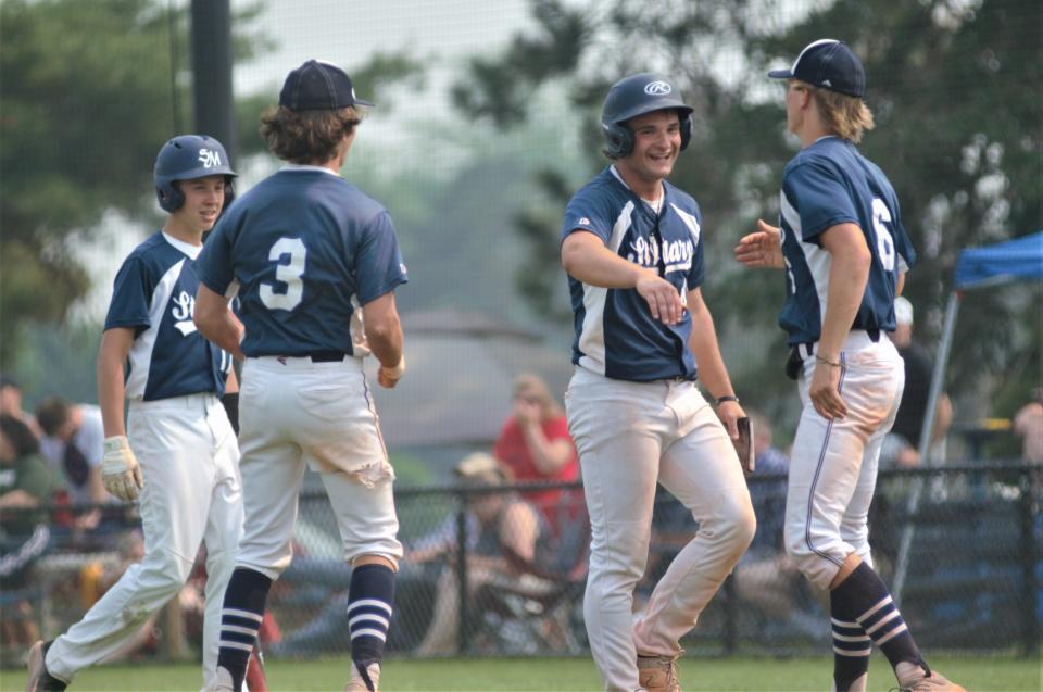 Gaylord St. Mary's celebrates Dillon Croff's go-ahead run during an MHSAA Division 4 district final between Gaylord St. Mary and Johannesburg-Lewiston on Saturday, June 3 in Gaylord, Mich.