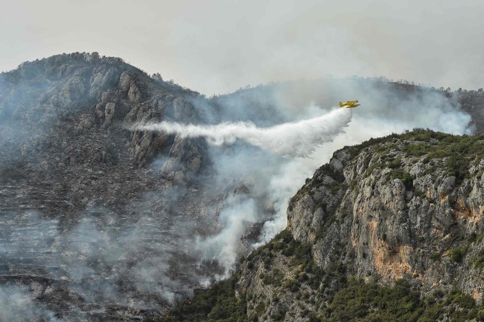 An Air Tractor AT-802A firefighting plane drops water on a wildfire near Artesa de Segre in Catalonia (AFP/Getty)