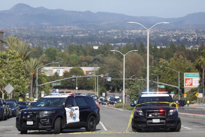 Police cars are seen after a deadly shooting at Geneva Presbyterian Church in Laguna Woods