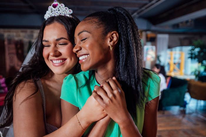 A bride-to-be and her friend hugging